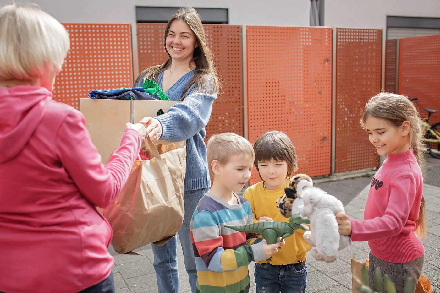 Volunteers handing bags of supplies to children