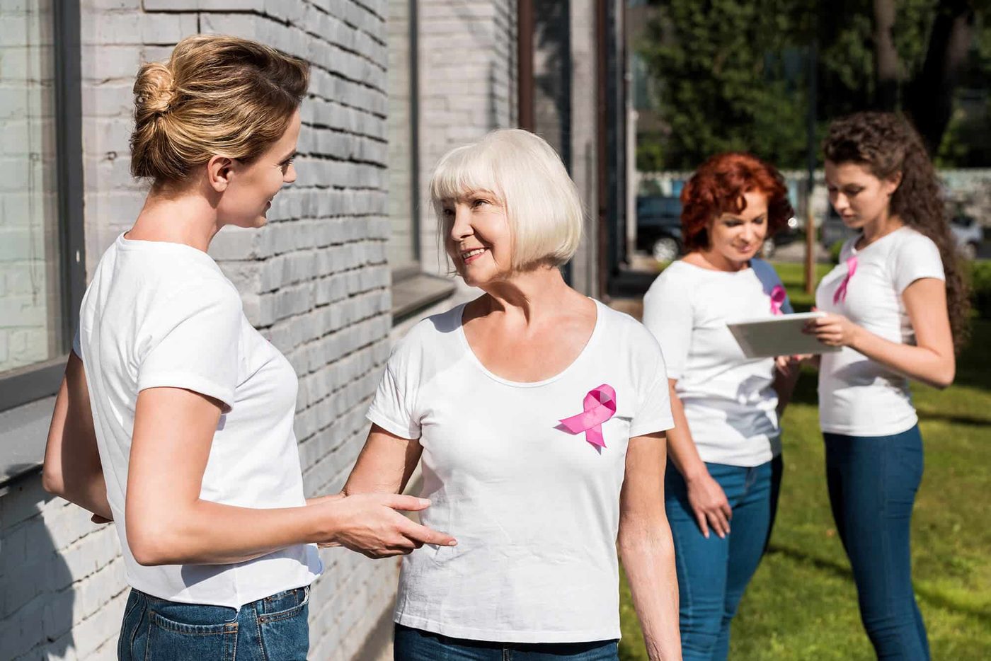 Volunteers talking together outside a community building